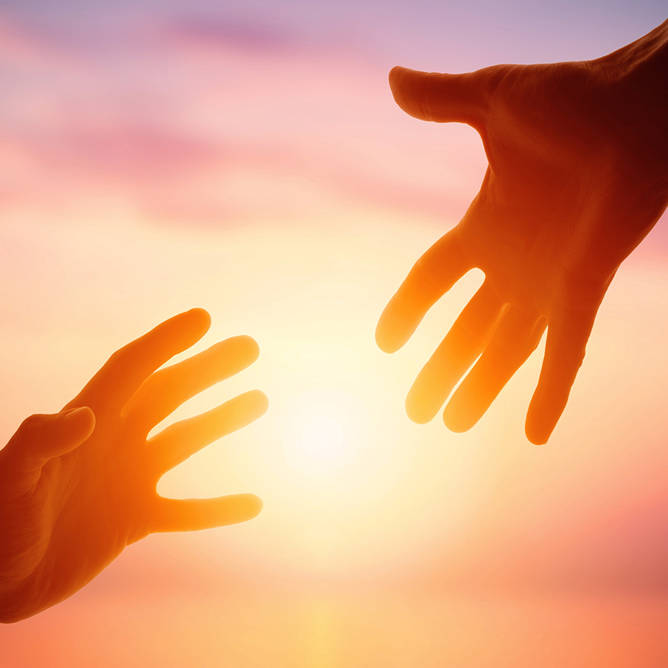 Giving a helping hand on the background of the dawn